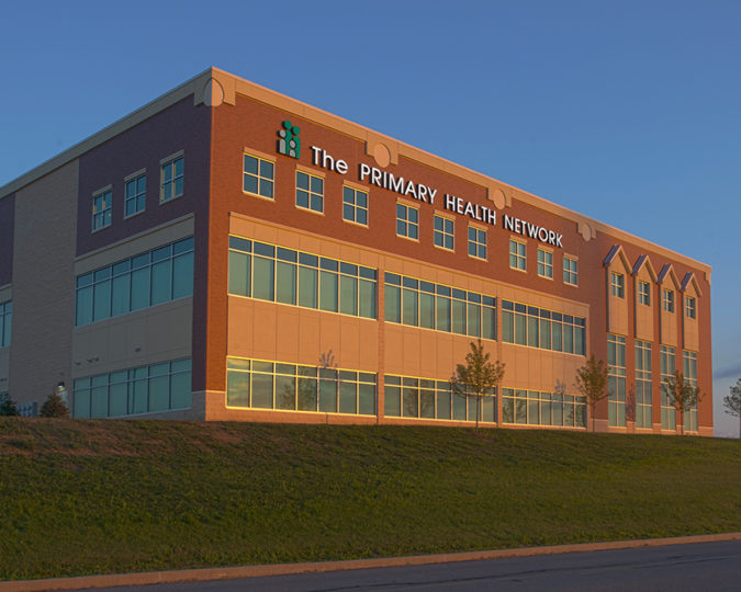 Outside view of the Clarion Community Health Center, a multi-story brick building with many windows.
