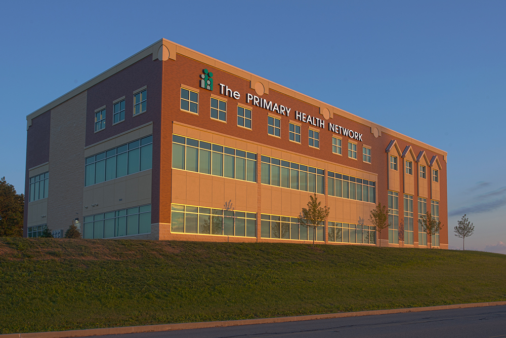 Outside view of the Clarion Community Health Center, a multi-story brick building with many windows.