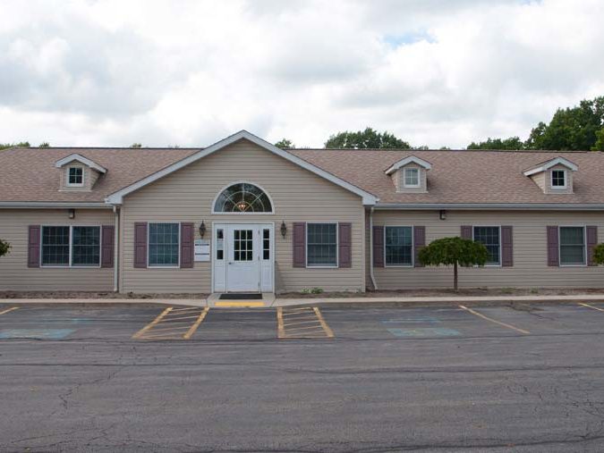 Outside the Sheakleyville Health Center building. View of the parking lot.