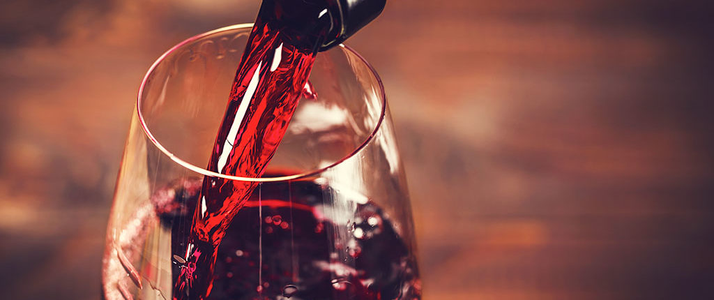 Extreme close up of red wine being poured into a glass