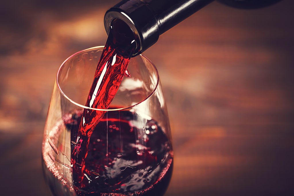 Extreme close up of red wine being poured into a glass