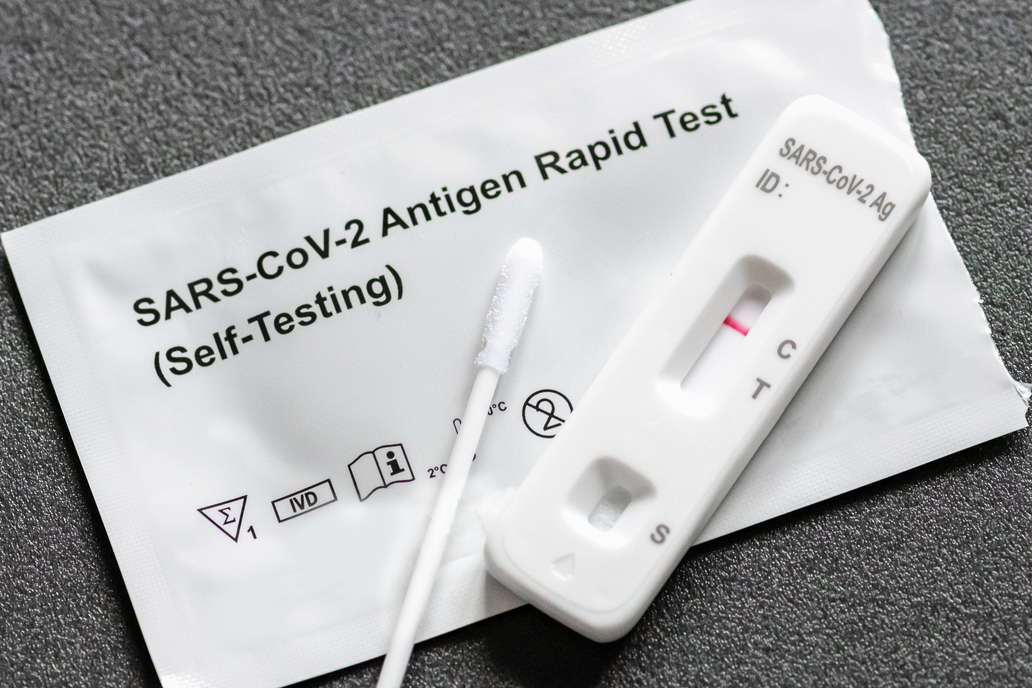 A negative at-home COVID self-test. The package reads "SARS-CoV-2 Antigen Rapid Test (Self-Testing)"