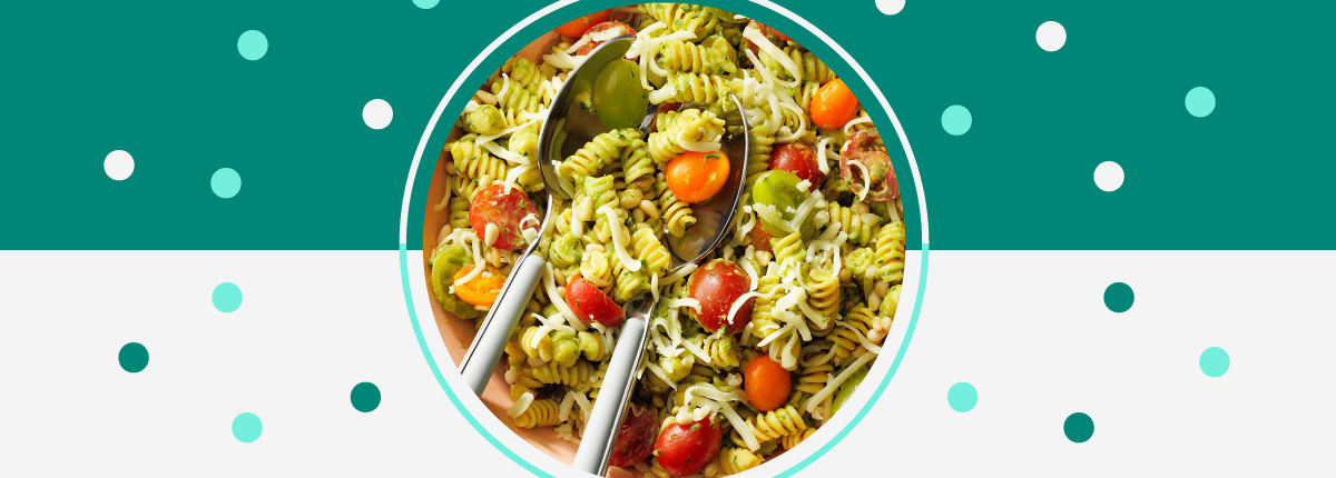 Cherry tomato spiral pasta bowl with serving spoons