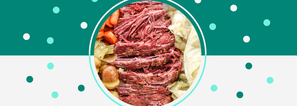 Corned beef with vegetable sides, cabbage, baby potatoes, celery, and carrots