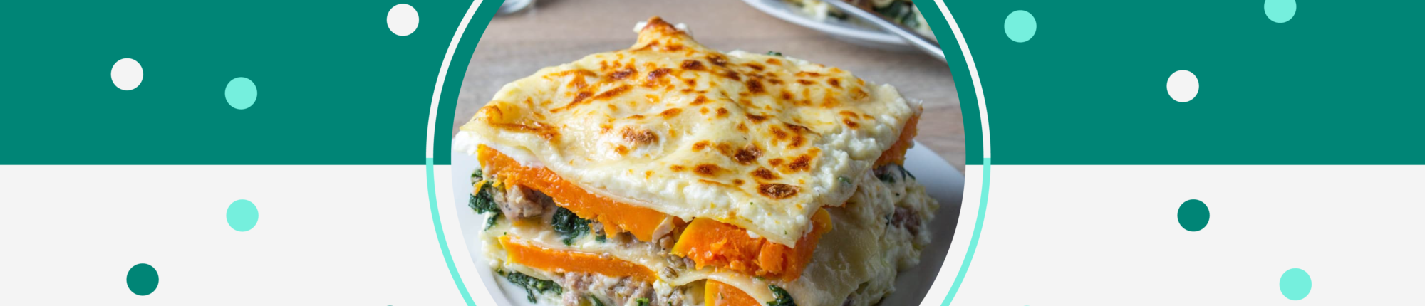 Cheesy, veggie lasagna on plate. Layers of noodles, butternut squash, sausage, sage, and cheese