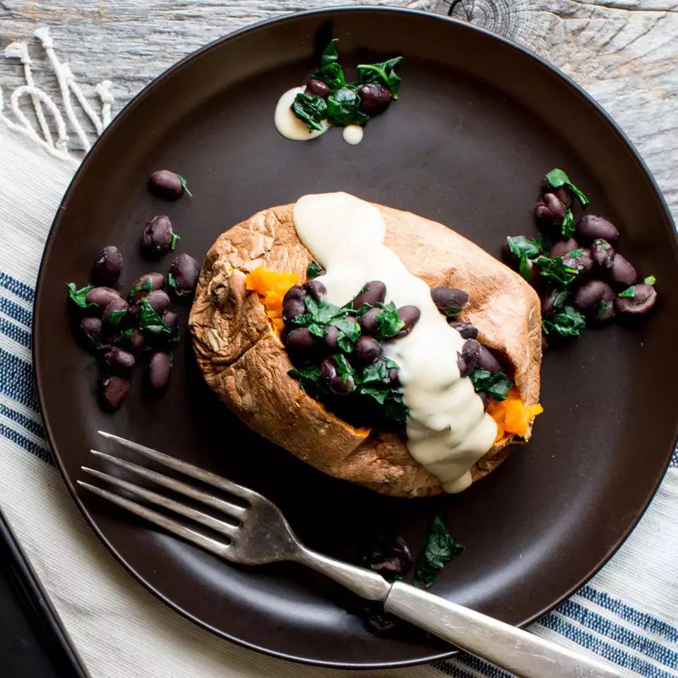 Stuffed baked sweet potato with hummus dressing topped with black beans - healthy recipes