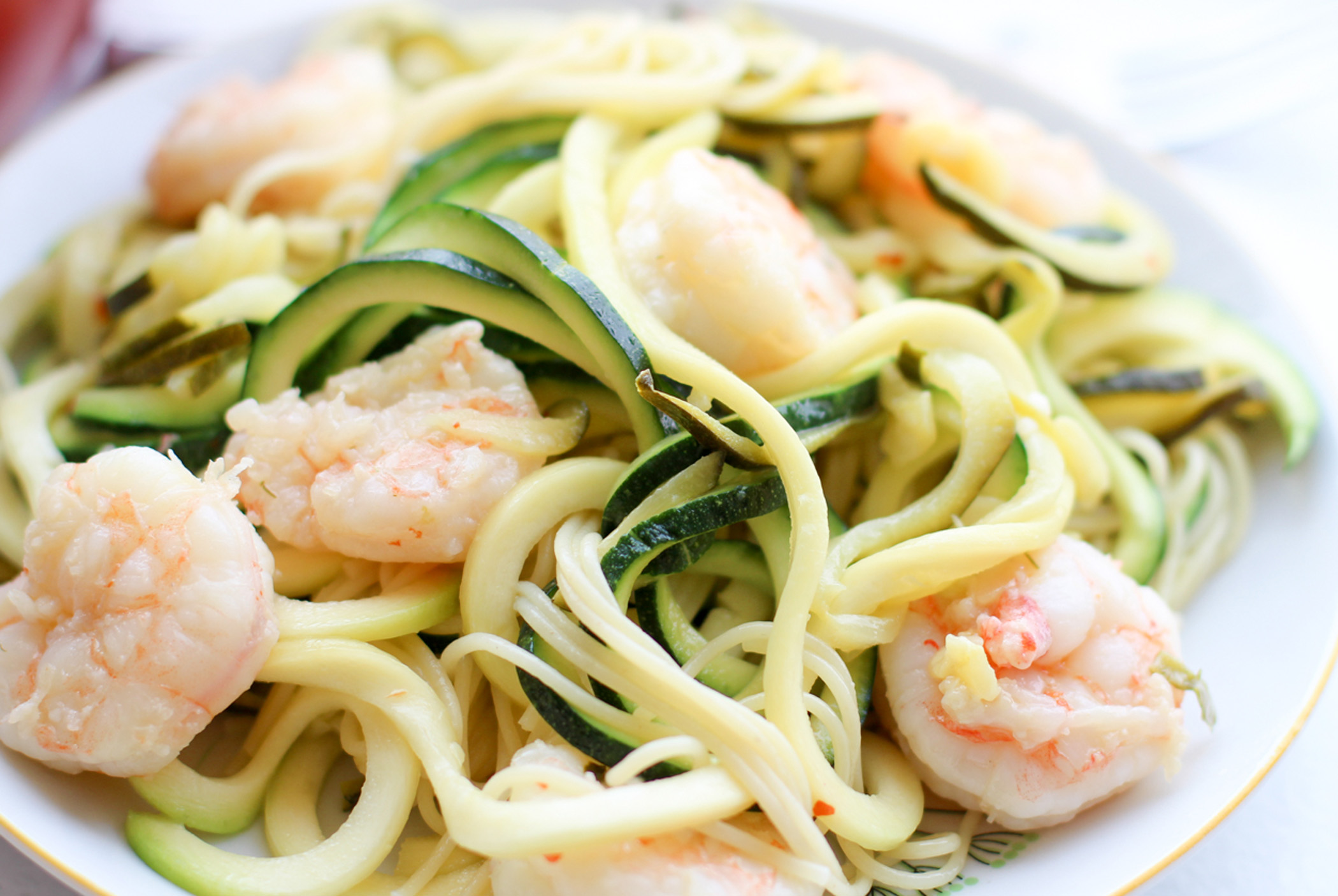 Extreme close-up of shrimp scampi made using spaghetti-type noodles made from zucchini