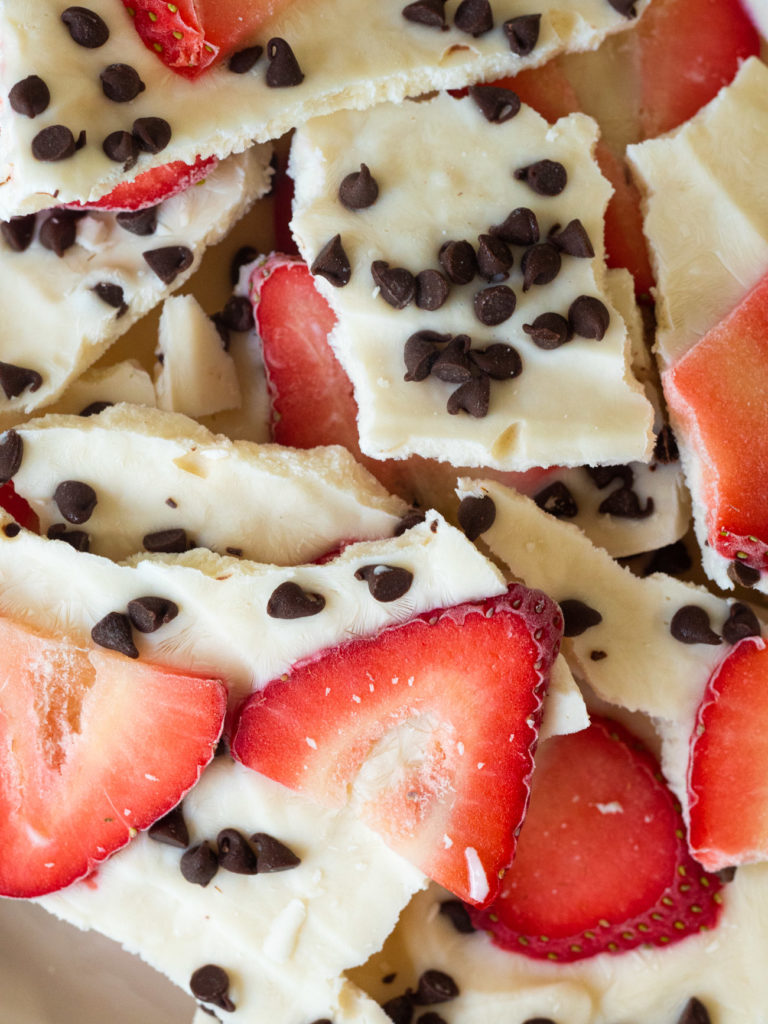Close-up of frozen Greek yogurt bark with mini chocolate chips and strawberry slices