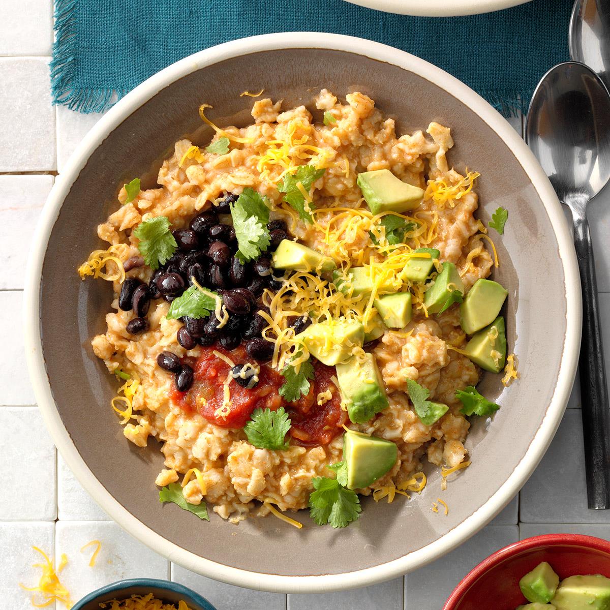 Tex-mex grain bowl, hot cereal topped with beans, avocado, and shredded cheese
