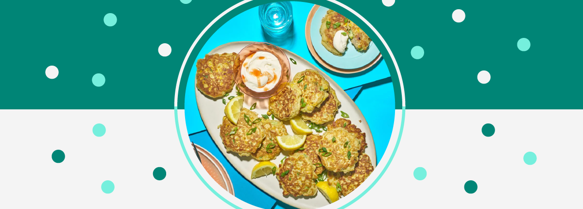 Plate full of tuna, spring onions and sweetcorn fritters with sour cream dipping sauce