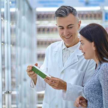 Pharmacy worker recommending a new product to a female patient