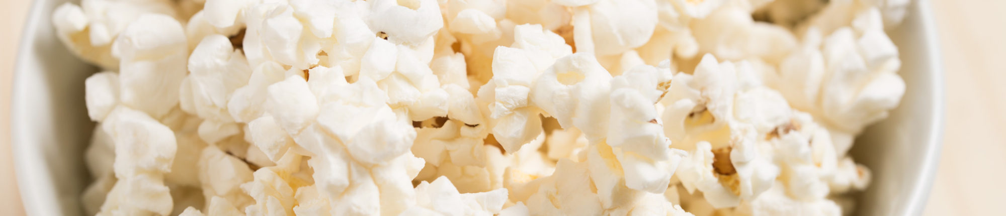 Extreme close-up of popcorn in a white bowl