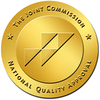 Gold The Joint Commission National Quality Approval seal on white background