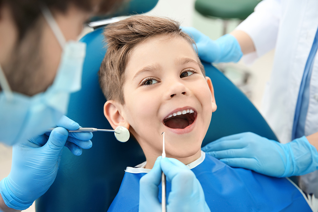 Child Smiling in Dentist Chair