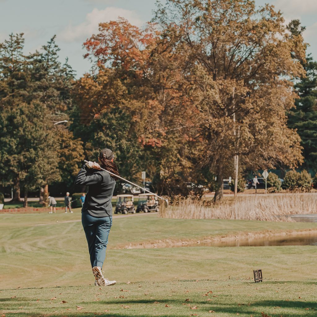 A female golfer teeing off