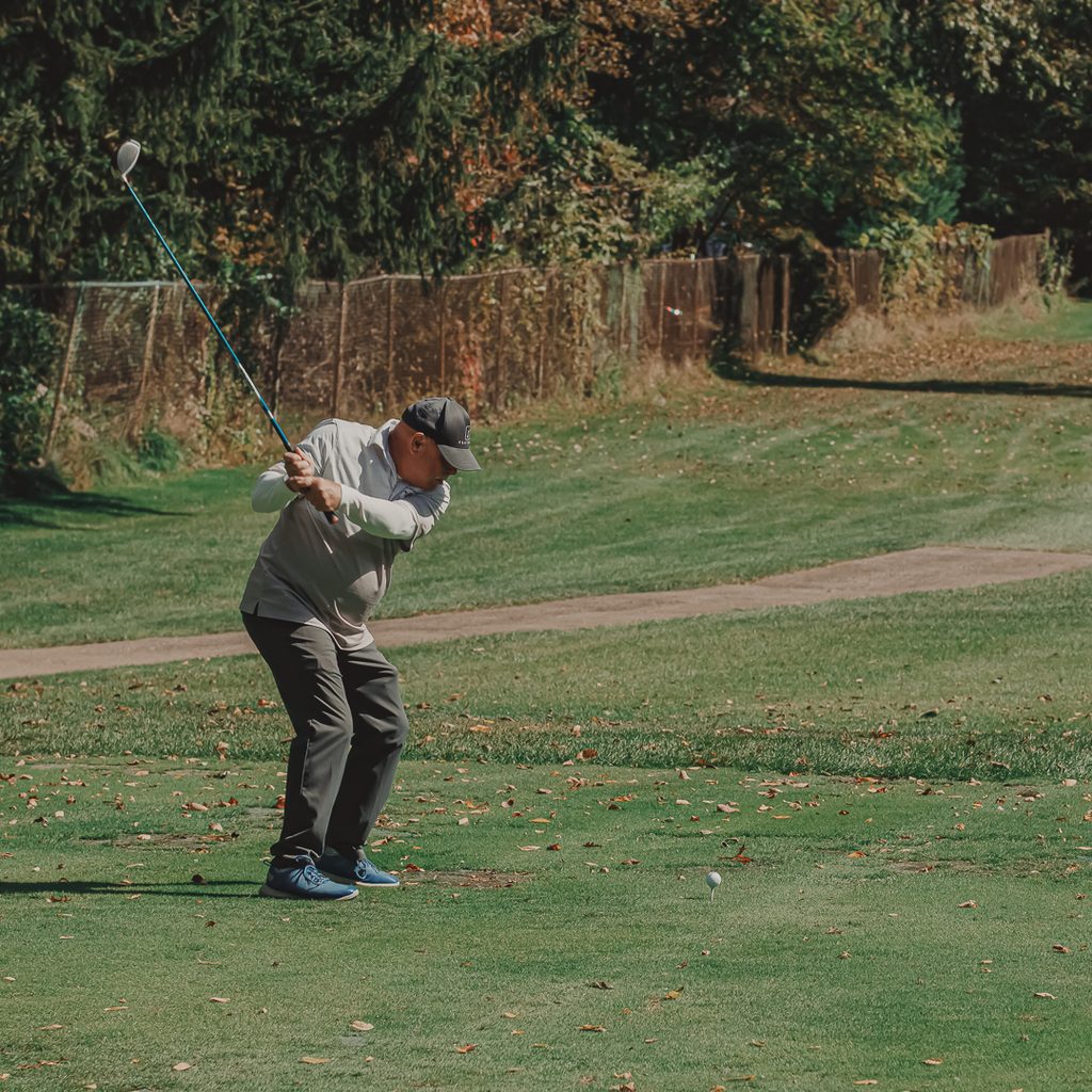 A male golfer teeing off