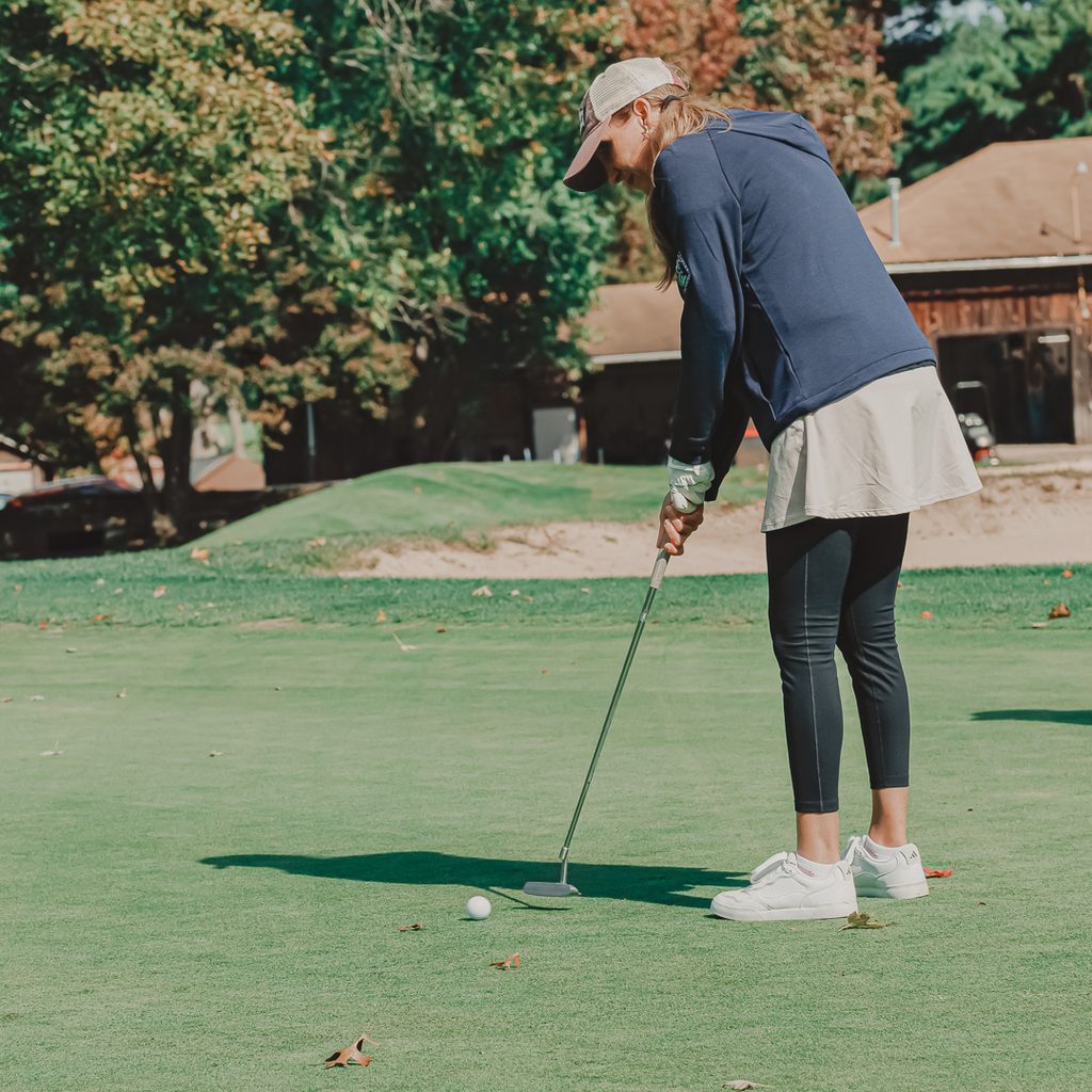 A female golfer putting