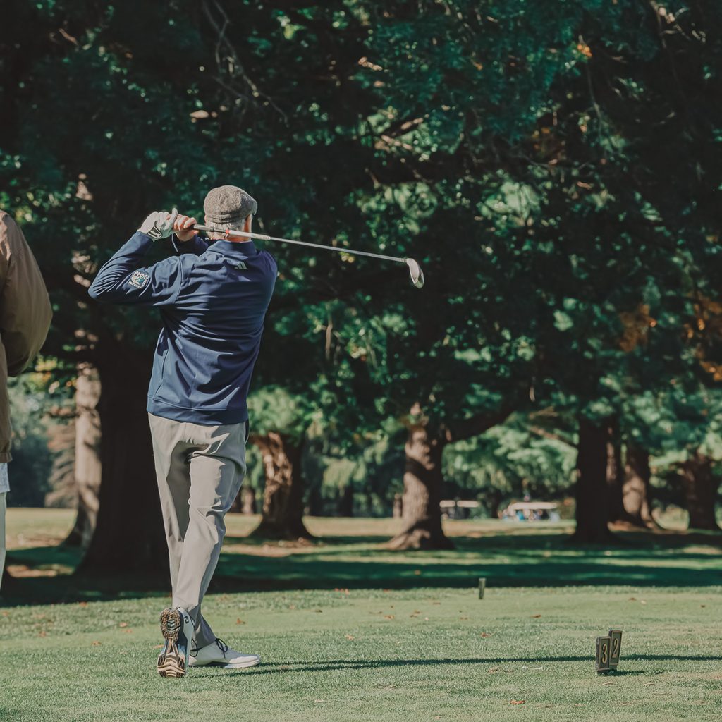 A male golfer teeing off