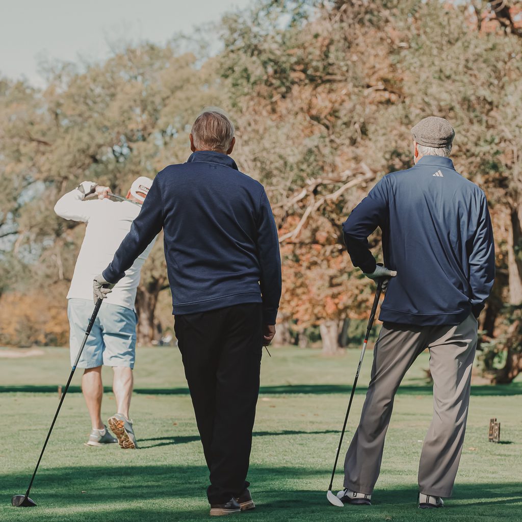 A group of male golfers standing