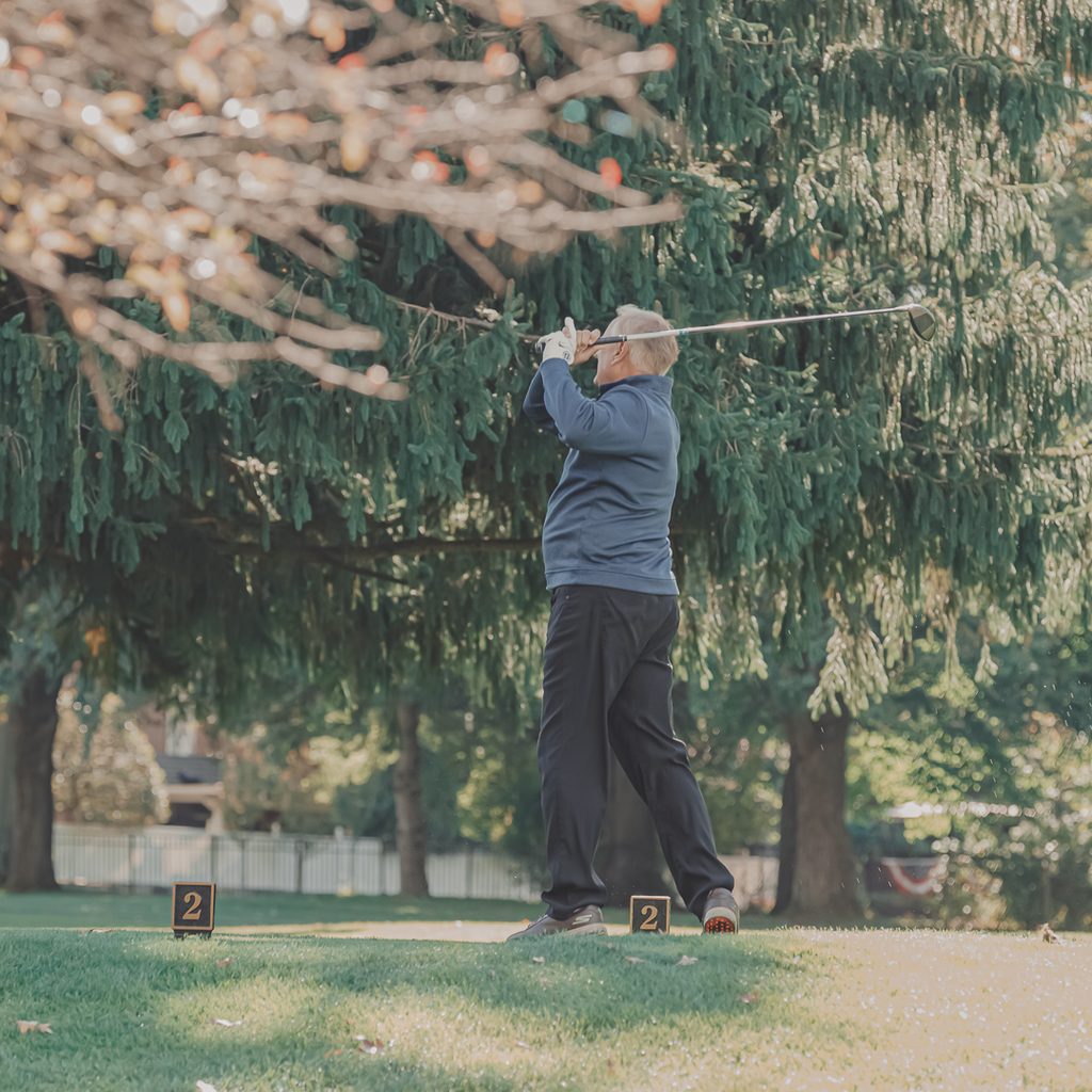 A male golfer hitting from the tee box