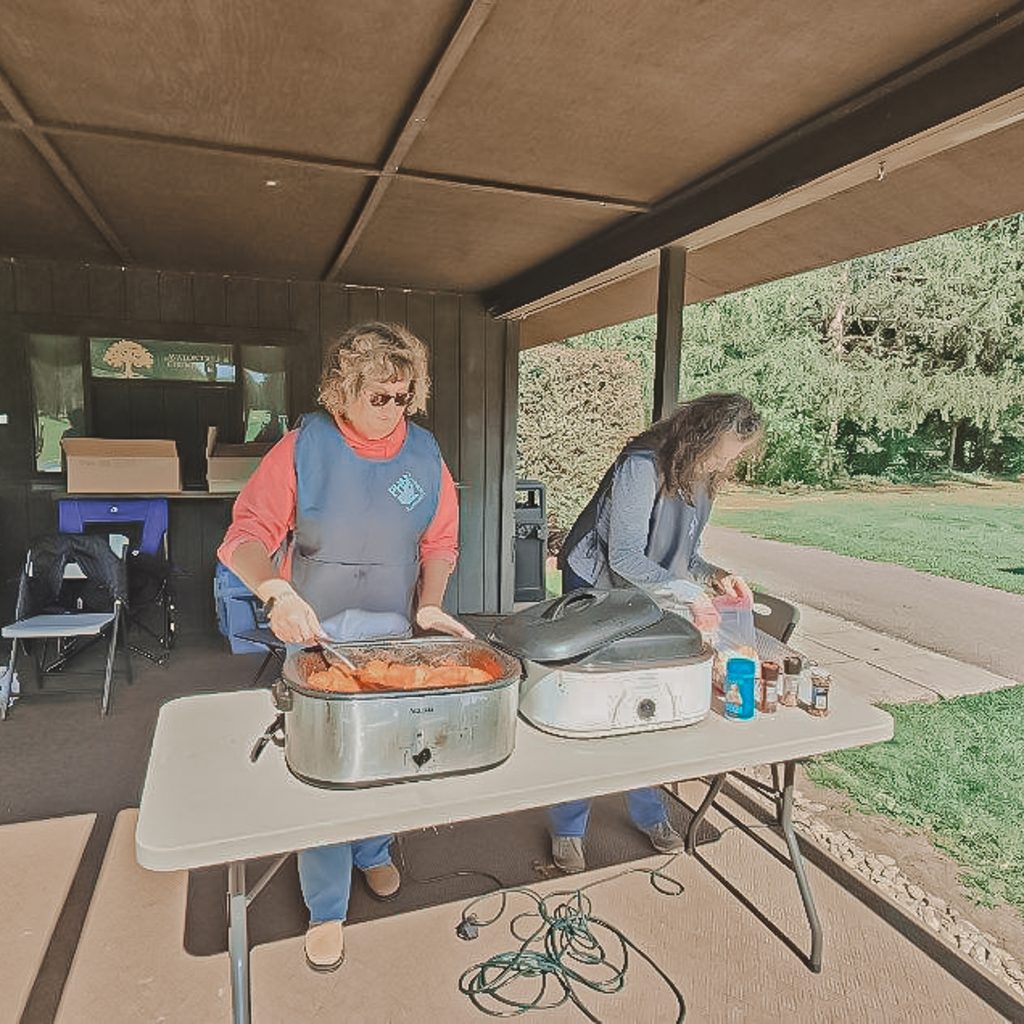Two female volunteers preparing food