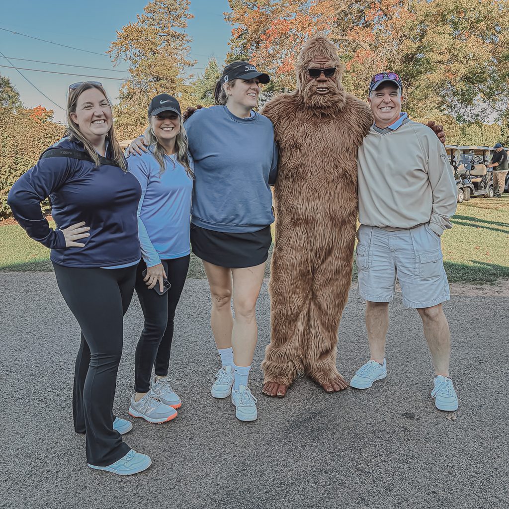 A group of golfers posing with the Sharon Sasquatch