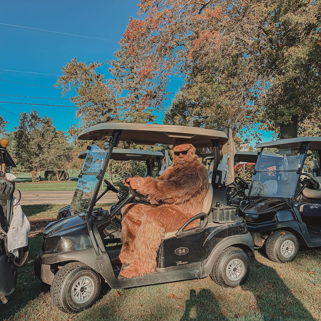 The Sharon Sasquatch sitting in a golf cart
