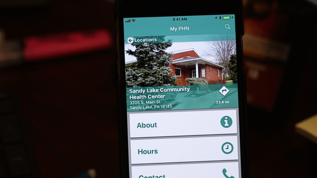 Smartphone showing the home screen of MyPHN app with main menu icons for appointments, messages, and health resources.