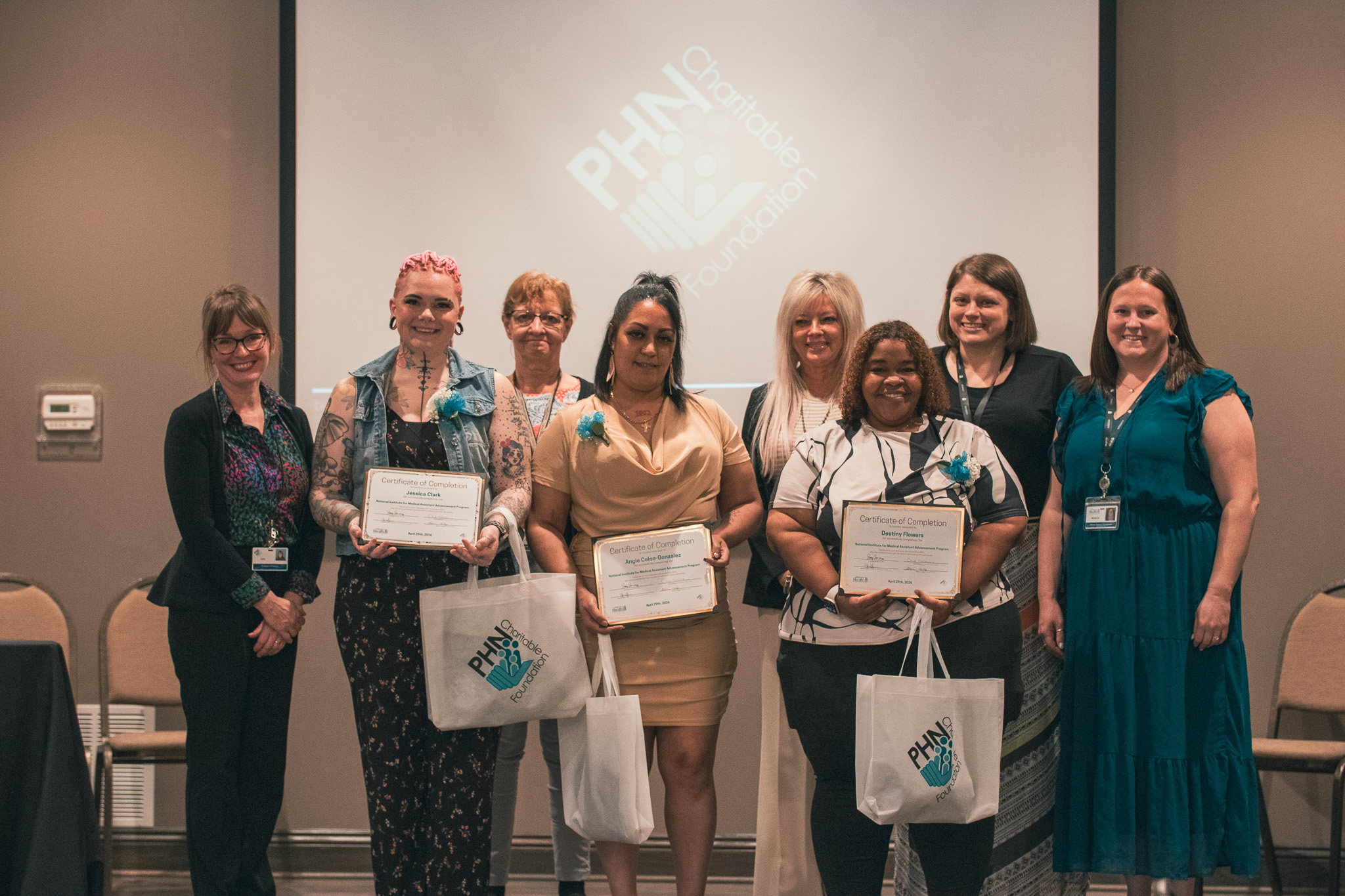 A group photo featuring PHN Charitable Foundation and the three NIMAA graduates Angie, Destiny, & Jessica.
