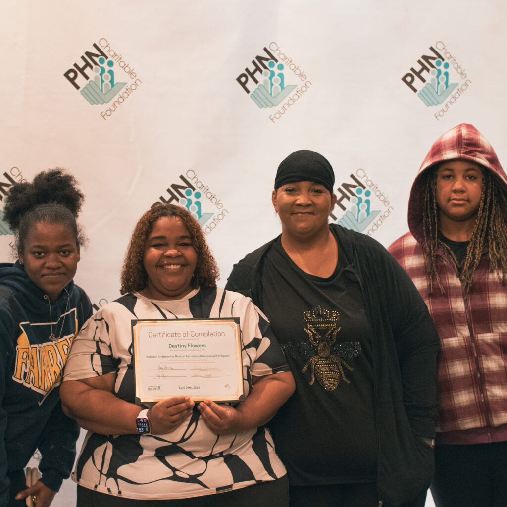 Group photo featuring Destiny Flowers holding her certificate for graduating from the 2025-2026 NIMAA cohort.