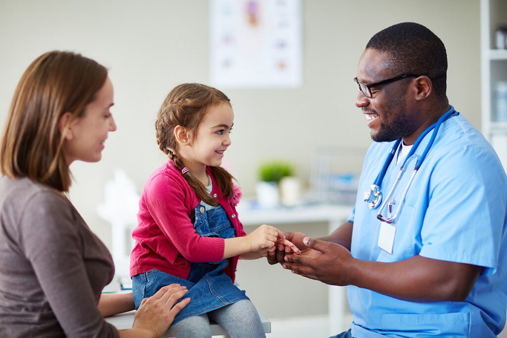 Provider holding girls hand